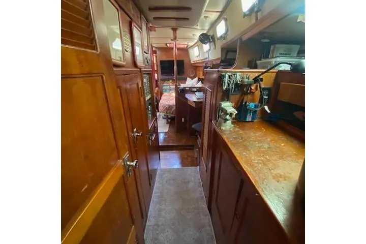 Slide: The Image of Interior of 1982 Endeavour 40 sailboat with wooden cabinetry and cozy living space. - 58