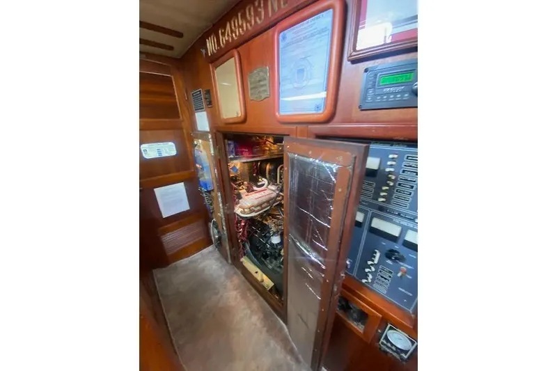 Slide: The Image of Engine room of a 1982 Endeavour 40 sailboat with control panels and equipment. - 59