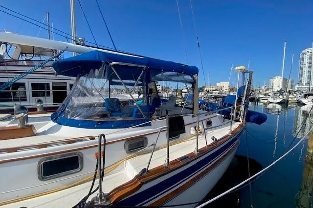 Slide: The Image of 1982 Endeavour 40 sailboat docked in a marina under clear blue skies. - 6
