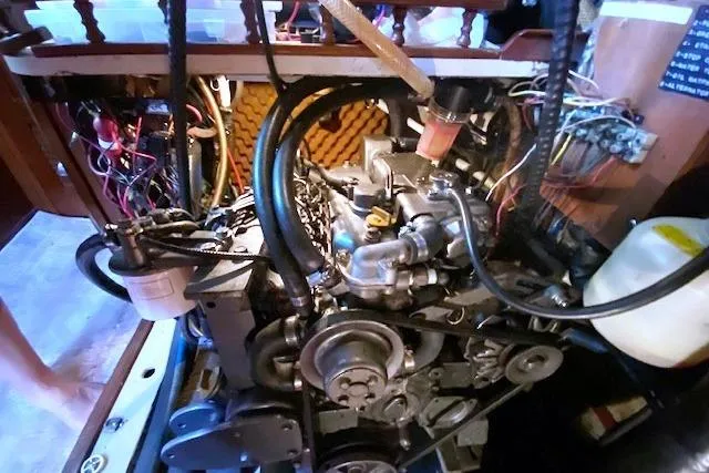 Slide: The Image of Engine compartment of a 1982 Endeavour 40 sailboat, showcasing intricate wiring and components. - 62