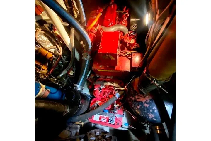 Slide: The Image of Engine room of a 1982 Endeavour 40 sailboat, featuring complex machinery and wiring. - 64