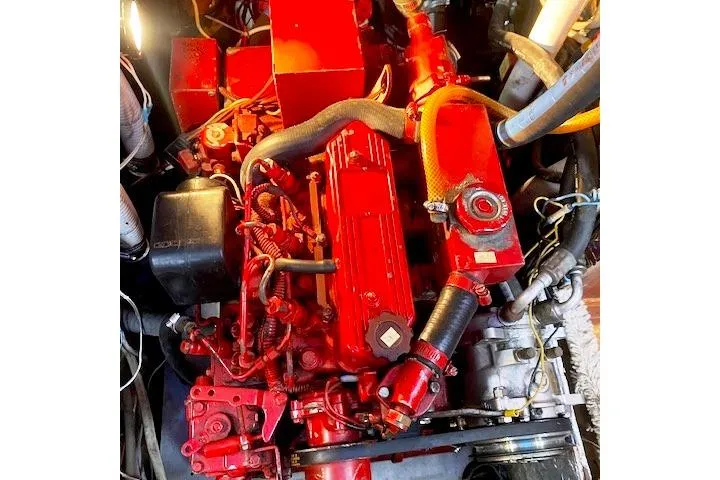 Slide: The Image of Red engine of a 1982 Endeavour 40 sailboat, showcasing intricate mechanical components. - 65