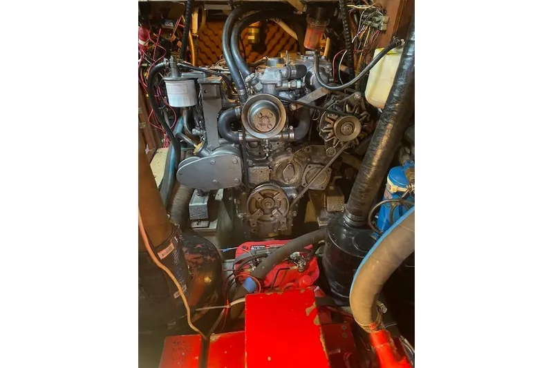 Slide: The Image of Engine compartment of a 1982 Endeavour 40 sailboat, showcasing mechanical components and wiring. - 66