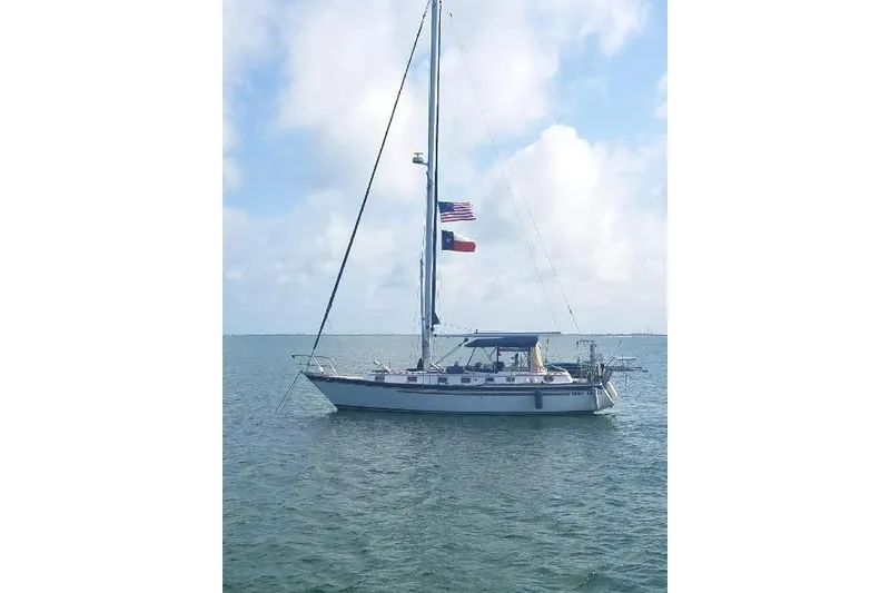 Slide: The Image of Sailboat Endeavour 40 (1982) on calm water under a blue sky. - 68