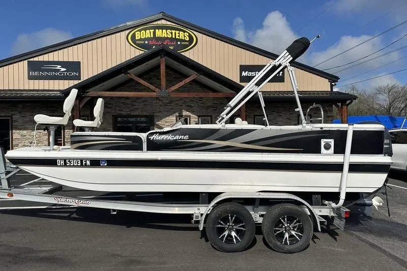 The Image of 2026 Hurricane FunDeck 196 RE boat on trailer at dealership, sunny day. - 0