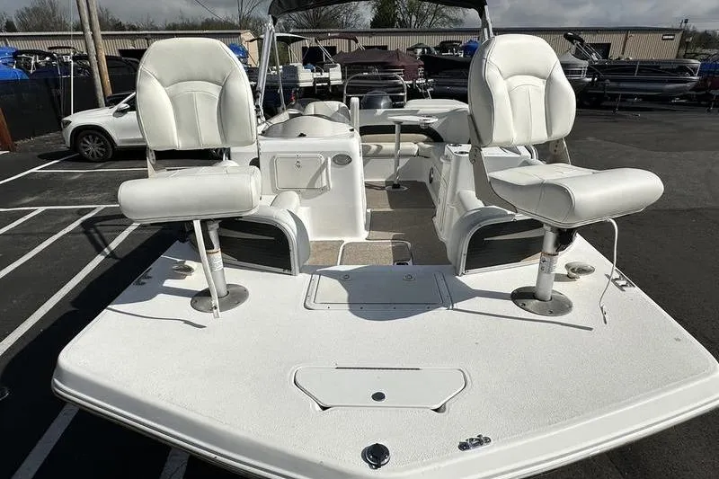 Slide: The Image of 2026 Hurricane FunDeck 196 RE boat with white seating, parked outdoors. - 10