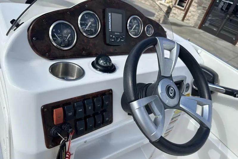 Slide: The Image of 2026 Hurricane FunDeck 196 RE boat dashboard with steering wheel and gauges. - 12