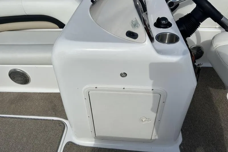 Slide: The Image of 2026 Hurricane FunDeck 196 RE boat console with storage compartment and cup holder. - 14