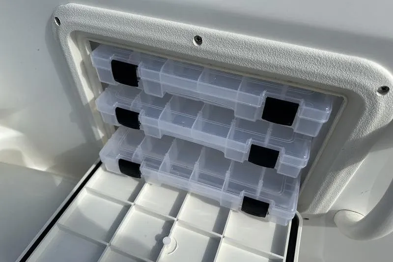 Slide: The Image of Storage compartment with clear tackle boxes on a 2026 Hurricane FunDeck 196 RE boat. - 17