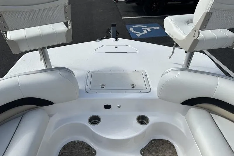 Slide: The Image of 2026 Hurricane FunDeck 196 RE boat interior with white seating and storage compartments. - 18