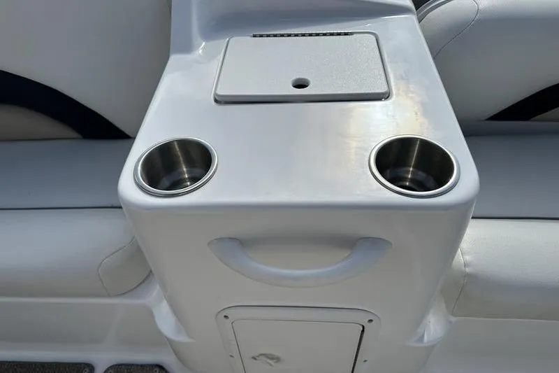 Slide: The Image of 2026 Hurricane FunDeck 196 RE boat interior with cup holders and storage compartment. - 19