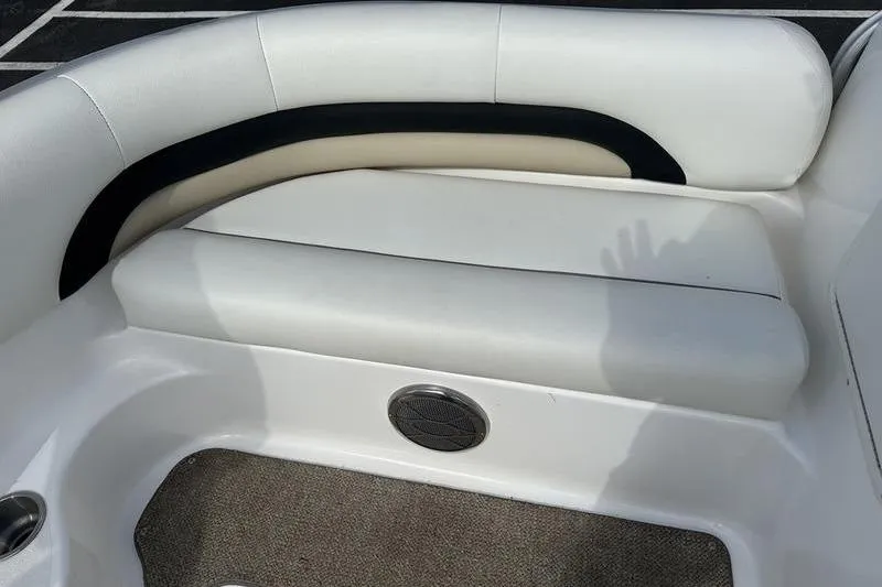 Slide: The Image of 2026 Hurricane FunDeck 196 RE boat interior with white cushioned seating and speaker. - 21