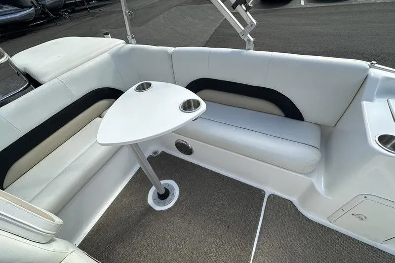 Slide: The Image of 2026 Hurricane FunDeck 196 RE boat interior with cushioned seating and a triangular table. - 22