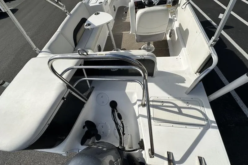 Slide: The Image of 2026 Hurricane FunDeck 196 RE boat interior with seating and steering console. - 3