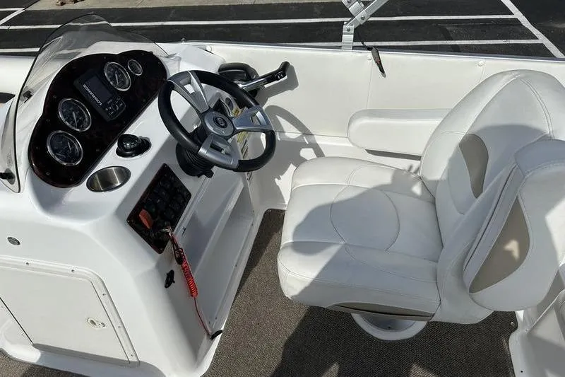 Slide: The Image of 2026 Hurricane FunDeck 196 RE boat interior with steering console and white captain's chair. - 8