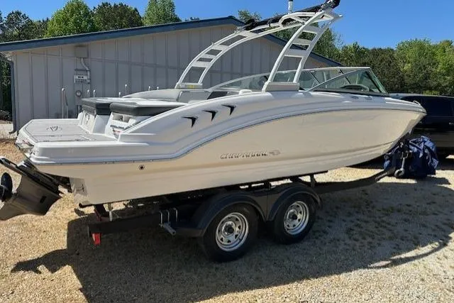 Slide: The Image of 2023 Chaparral 23 SSi boat on trailer, parked outdoors near a building. - 17