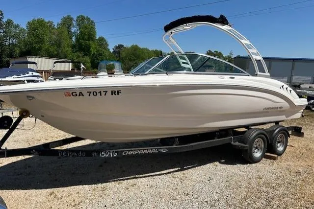 Slide: The Image of 2023 Chaparral 23 SSi boat on trailer, parked outdoors on gravel. - 18