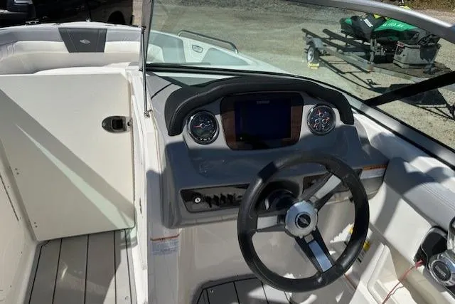 Slide: The Image of 2023 Chaparral 23 SSi boat dashboard with steering wheel and control panel. - 21