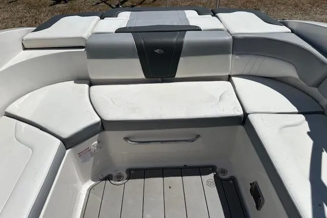 Slide: The Image of 2023 Chaparral 23 SSi boat interior with cushioned seating and sleek design. - 23