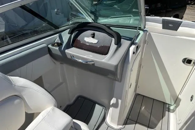 Slide: The Image of 2023 Chaparral 23 SSi boat interior with steering wheel and seating area. - 24