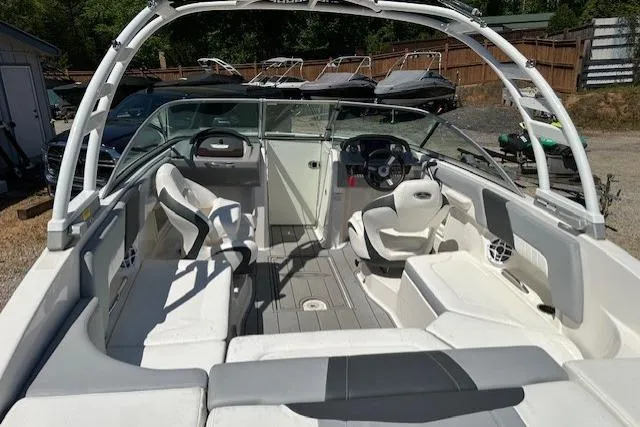 Slide: The Image of 2023 Chaparral 23 SSi boat interior with white seating and steering console. - 25
