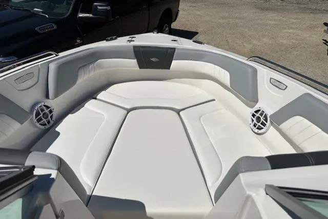 Slide: The Image of 2023 Chaparral 23 SSi boat interior with white cushioned seating and speakers. - 26