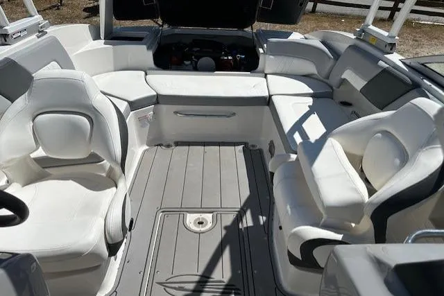 Slide: The Image of 2023 Chaparral 23 SSi boat interior with white seating and open engine compartment. - 27