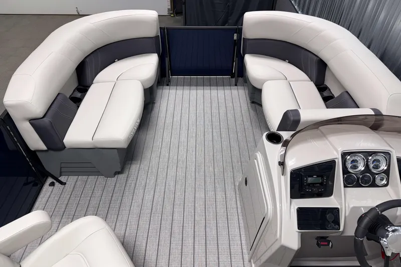 Slide: The Image of Interior of 2026 Sylvan Mirage 8520 LZ PTS Tritoon with luxurious seating and modern dashboard. - 13