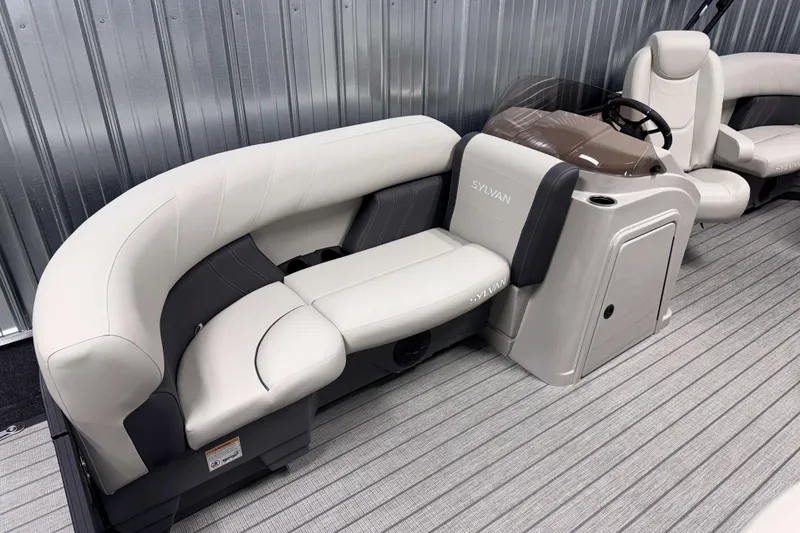 Slide: The Image of 2026 Sylvan Mirage 8520 LZ PTS Tritoon interior with plush seating and sleek design. - 15