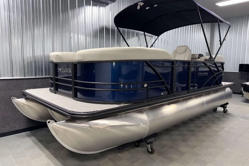 Slide: The Image of 2026 Sylvan Mirage 8520 LZ PTS Tritoon in showroom, featuring sleek design and modern amenities. - 16