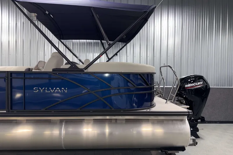 Slide: The Image of 2026 Sylvan Mirage 8520 LZ PTS Tritoon with Mercury engine in a showroom. - 21