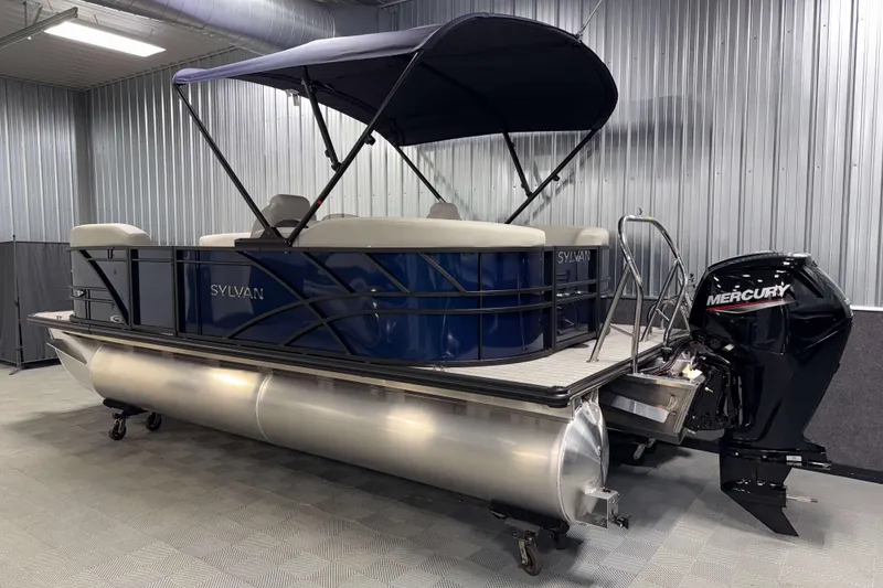 Slide: The Image of 2026 Sylvan Mirage 8520 LZ PTS Tritoon with Mercury engine in a showroom. - 22