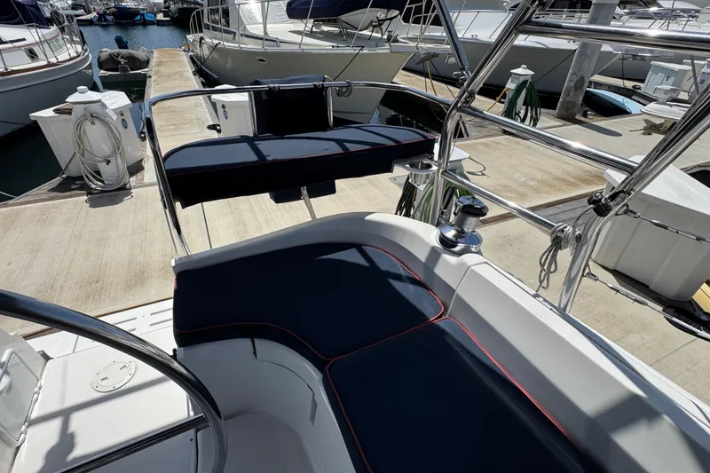 Slide: The Image of 2004 Hunter 41 Aft Cockpit sailboat with navy cushions docked at marina. - 20