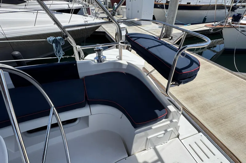 Slide: The Image of 2004 Hunter 41 Aft Cockpit with blue cushions in marina. - 23