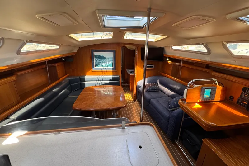 Slide: The Image of Luxurious interior of 2004 Hunter 41 Aft Cockpit sailboat with wood finishes and seating area. - 26