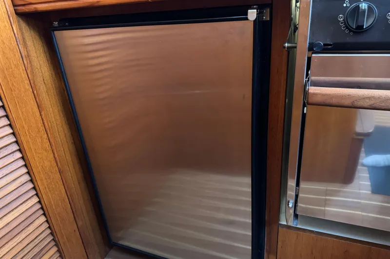 Slide: The Image of Stainless steel fridge in 2004 Hunter 41 Aft Cockpit yacht kitchen. - 33
