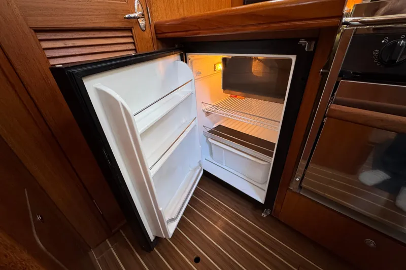 Slide: The Image of Open refrigerator in the galley of a 2004 Hunter 41 Aft Cockpit sailboat. - 34