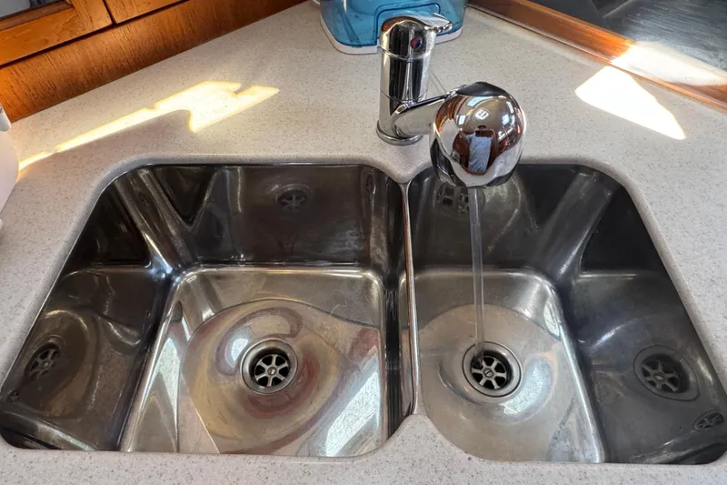 Slide: The Image of Stainless steel double sink with running water in a 2004 Hunter 41 Aft Cockpit yacht. - 36