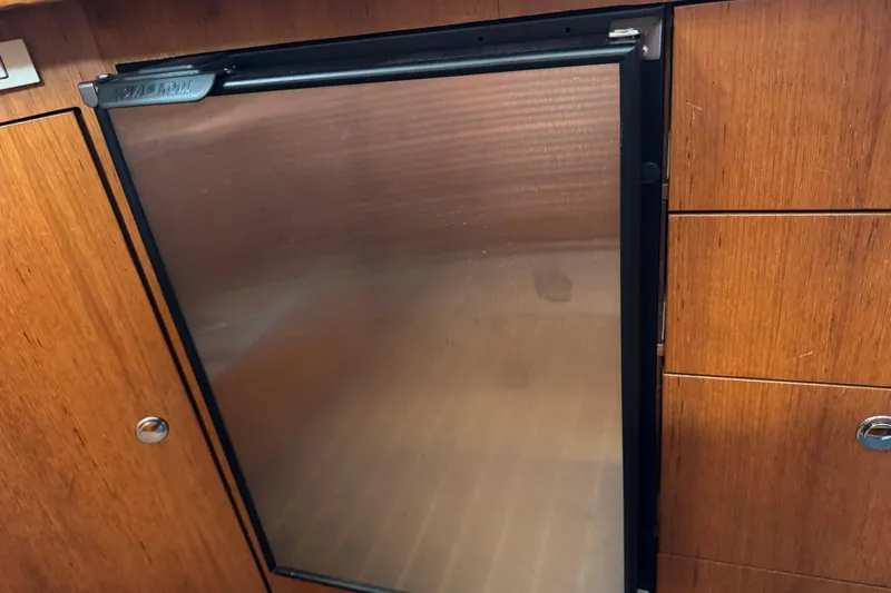 Slide: The Image of Wooden cabinetry with a stainless steel fridge on a 2004 Hunter 41 Aft Cockpit yacht. - 37