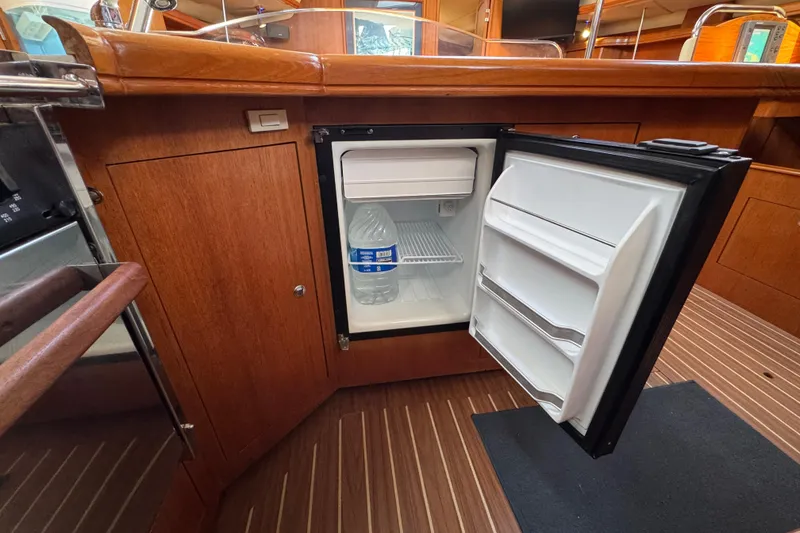 Slide: The Image of Open mini fridge in 2004 Hunter 41 Aft Cockpit yacht interior. - 38