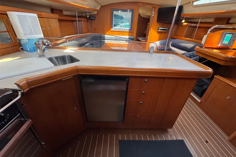 Slide: The Image of Luxurious 2004 Hunter 41 Aft Cockpit yacht interior with modern kitchen and wood finish. - 39
