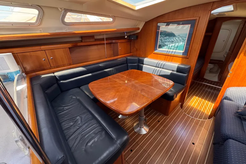 Slide: The Image of Luxurious interior of 2004 Hunter 41 Aft Cockpit yacht with wood finish and leather seating. - 41