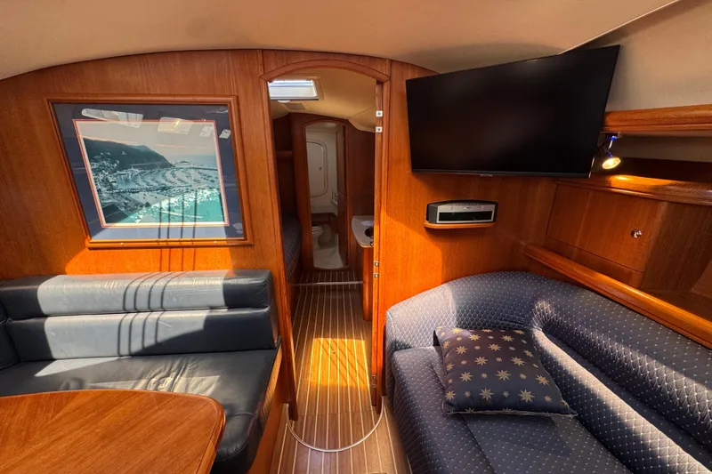 Slide: The Image of Interior of 2004 Hunter 41 Aft Cockpit yacht with cozy seating and wall art. - 42