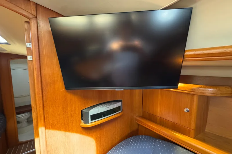 Slide: The Image of Interior of 2004 Hunter 41 Aft Cockpit yacht with mounted TV and audio system. - 43