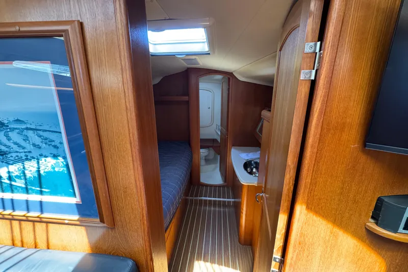 Slide: The Image of Interior of 2004 Hunter 41 Aft Cockpit yacht, featuring cozy cabin and wooden finishes. - 44