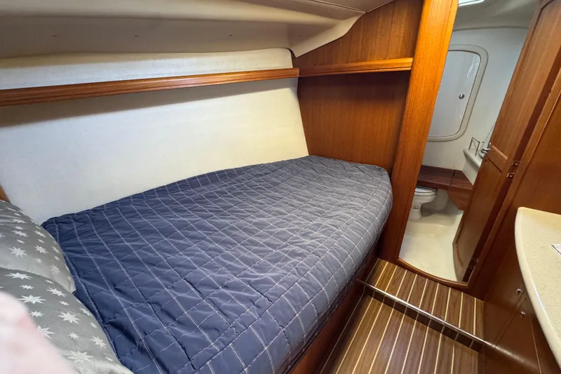 Slide: The Image of Cozy cabin interior of 2004 Hunter 41 Aft Cockpit sailboat with wooden finish and bed. - 46