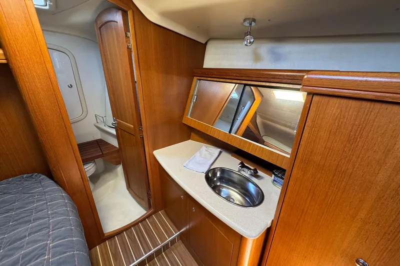 Slide: The Image of Interior of 2004 Hunter 41 Aft Cockpit yacht with wooden cabinetry and compact bathroom. - 47