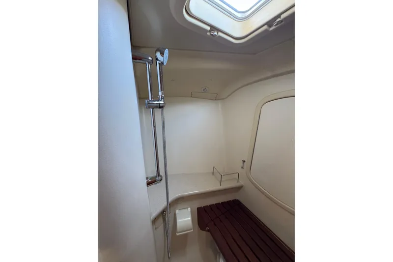 Slide: The Image of Interior shower area of 2004 Hunter 41 Aft Cockpit yacht with skylight and wooden bench. - 49