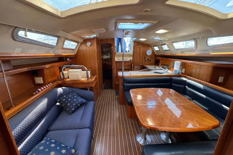 Slide: The Image of Interior of 2004 Hunter 41 Aft Cockpit sailboat with wood finish and seating area. - 52