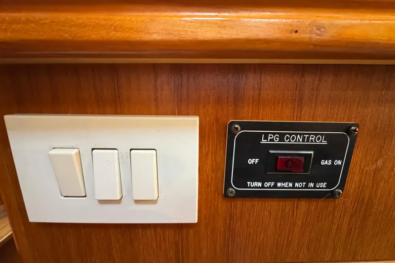 Slide: The Image of Control panel with LPG switch and light switches on a 2004 Hunter 41 Aft Cockpit yacht. - 55